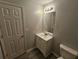 Cozy bathroom features a single sink vanity, mirror, and updated lighting at 500 Mica Trce, South Fulton, GA 30349