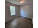 This bedroom features wood floors, natural light, and a modern overhead light fixture at 500 Mica Trce, South Fulton, GA 30349