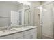 Double vanity bathroom with granite countertops, glass shower doors, and tile surround at 1095 Tucker Ave # 401, Atlanta, GA 30310