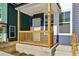 Inviting front porch with natural wood railings, number '401', and freshly landscaped yard at 1095 Tucker Ave # 401, Atlanta, GA 30310
