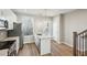 Sunlit kitchen featuring stainless steel appliances, an island and hardwood flooring at 1095 Tucker Ave # 401, Atlanta, GA 30310