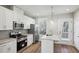 Bright kitchen with white cabinets, stainless steel appliances, and granite countertops at 1095 Tucker Ave # 401, Atlanta, GA 30310