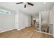 Spacious living room showcasing wood floors, recessed lighting, a stairway, and open layout at 1095 Tucker Ave # 401, Atlanta, GA 30310