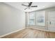 Bright and airy room with wood-look floors, white trim, large windows, and a ceiling fan at 1095 Tucker Ave # 401, Atlanta, GA 30310