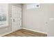 Clean, modern room with light wood floors, a crisp white door, and ample natural light at 1095 Tucker Ave # 401, Atlanta, GA 30310