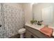 Clean bathroom with gray vanity and patterned shower curtain at 91 Pinewood Dr, Covington, GA 30014