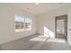 Well-lit bedroom with carpet and access to another room at 91 Pinewood Dr, Covington, GA 30014