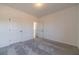 Bright bedroom with gray carpet and neutral walls at 91 Pinewood Dr, Covington, GA 30014