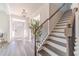 Elegant entryway with hardwood floors, a staircase, and a large front door at 91 Pinewood Dr, Covington, GA 30014