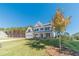 Two-story white farmhouse with a tree in front, large windows, and a green lawn at 91 Pinewood Dr, Covington, GA 30014