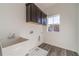 Laundry room with upper cabinets, sink, and window at 91 Pinewood Dr, Covington, GA 30014