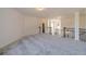 Spacious loft area with gray carpet and neutral walls at 91 Pinewood Dr, Covington, GA 30014