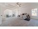 Large main bedroom with a tray ceiling, ceiling fan, and ample natural light at 91 Pinewood Dr, Covington, GA 30014