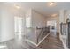 Spacious upstairs hallway with wooden railing and neutral floors at 91 Pinewood Dr, Covington, GA 30014