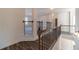 Upstairs hallway showcasing a wooden railing and dark flooring at 91 Pinewood Dr, Covington, GA 30014