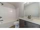 Bathroom with tub, shower, vanity, and dark brown cabinets at 125 Pinewood Dr, Covington, GA 30014