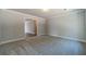 Grey carpeted bedroom with access to another room at 125 Pinewood Dr, Covington, GA 30014