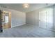 Bedroom with grey carpet and access to hallway at 125 Pinewood Dr, Covington, GA 30014