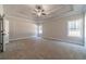 Spacious bedroom with neutral carpeting and large windows offering natural light at 125 Pinewood Dr, Covington, GA 30014