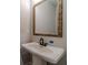 Powder room with pedestal sink and ornate mirror at 125 Pinewood Dr, Covington, GA 30014