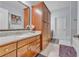 Bathroom featuring double sink vanity with granite countertop and wooden cabinetry at 3621 Vinings Slope Se # 3202, Atlanta, GA 30339