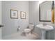 Powder room featuring a pedestal sink, a toilet, and tiled floors at 3621 Vinings Slope Se # 3202, Atlanta, GA 30339