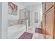 Bathroom featuring a soaking tub, glass shower and built-in wooden cabinet at 3621 Vinings Slope Se # 3202, Atlanta, GA 30339