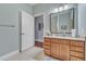 Bathroom featuring a single sink vanity with granite countertop and wooden cabinetry at 3621 Vinings Slope Se # 3202, Atlanta, GA 30339