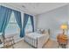 Bedroom with two large windows, a rocking chair, and a side table with a lamp at 3621 Vinings Slope Se # 3202, Atlanta, GA 30339