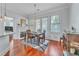 Bright dining area with hardwood floors, fireplace, and access to balcony with natural light at 3621 Vinings Slope Se # 3202, Atlanta, GA 30339