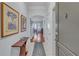 Inviting hallway with hardwood floors, artwork, and a view into the open concept living space at 3621 Vinings Slope Se # 3202, Atlanta, GA 30339