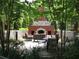 Cozy outdoor fireplace with seating area surrounded by lush greenery at 3621 Vinings Slope Se # 3202, Atlanta, GA 30339