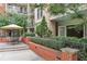 Cozy brick patio with an umbrella table and chairs, surrounded by greenery at 3621 Vinings Slope Se # 3202, Atlanta, GA 30339