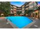 Inviting condo complex pool with lounge chairs and shaded seating at dusk at 3621 Vinings Slope Se # 3202, Atlanta, GA 30339