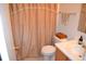 Cozy bathroom with neutral tones, vanity, toilet and shower with decorative curtain at 1007 Sycamore Ln, Villa Rica, GA 30180