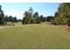 Well-manicured green golf course framed by mature trees, creating a serene atmosphere at 1007 Sycamore Ln, Villa Rica, GA 30180