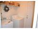 Functional laundry room with a washer and dryer, ample storage and a decorative wreath at 1007 Sycamore Ln, Villa Rica, GA 30180