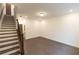 Finished basement area with dark floors, recessed lighting, and an adjacent staircase at 326 Olmstead Way # 41, Alpharetta, GA 30022