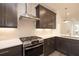 Well-lit kitchen featuring stainless steel appliances, modern fixtures, and white backsplash tiles at 326 Olmstead Way # 41, Alpharetta, GA 30022