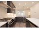 Modern kitchen with stainless steel range and hood, white countertops, and dark wood cabinets at 326 Olmstead Way # 41, Alpharetta, GA 30022