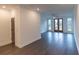 Bright living room featuring hardwood flooring, a ceiling fan, and double doors to an outdoor balcony at 326 Olmstead Way # 41, Alpharetta, GA 30022