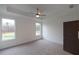 Spacious main bedroom featuring a ceiling fan, two windows, and neutral carpet at 326 Olmstead Way # 41, Alpharetta, GA 30022