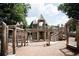 A wooden, castle themed playground is surrounded by mulch and framed by trees under a partly cloudy sky at 326 Olmstead Way # 41, Alpharetta, GA 30022