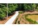 A meandering walking path winds through a wooded area alongside a pond surrounded by natural foliage at 326 Olmstead Way # 41, Alpharetta, GA 30022