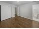 This bedroom features wood floors, white walls, and closet with bright natural light at 720 Smithstone Se Rd, Marietta, GA 30067
