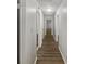 This is a long hallway with new wood flooring, white walls, and white doors at 720 Smithstone Se Rd, Marietta, GA 30067