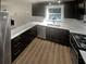 Modern kitchen featuring dark cabinets, granite countertops, and stainless steel appliances at 720 Smithstone Se Rd, Marietta, GA 30067