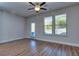 Bright bedroom with wood flooring, a ceiling fan, two windows, and access to a balcony at 3405 Ripple Loop # 127, South Fulton, GA 30349