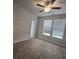 Bright bedroom featuring two large windows, plush carpet flooring, and a modern ceiling fan at 3405 Ripple Loop # 127, South Fulton, GA 30349