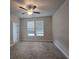 Bedroom featuring two large windows, plush carpet flooring, and a modern ceiling fan at 3405 Ripple Loop # 127, South Fulton, GA 30349